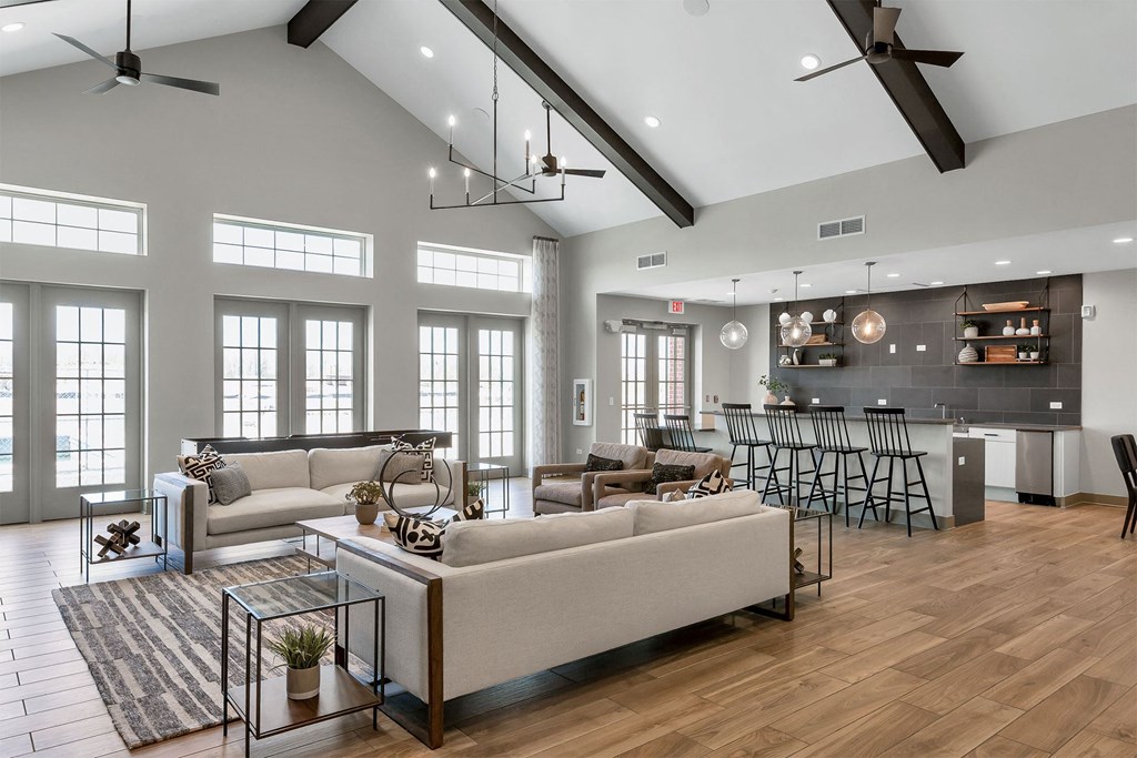 a living room with couches and a kitchen with a table and chairs