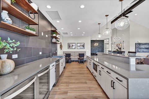 a large kitchen with stainless steel counter tops and a dining room