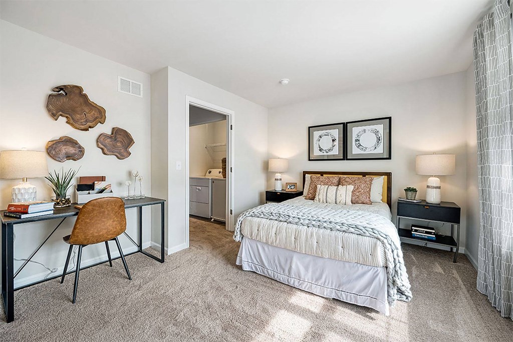 a bedroom with a bed and a desk