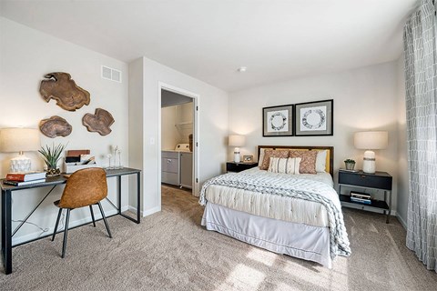 a bedroom with a bed and a desk