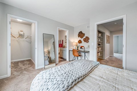 a bedroom with a large bed and a closet