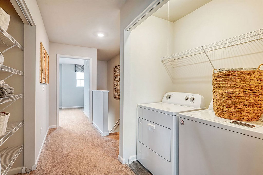 a laundry room with a washer and dryer and a closet