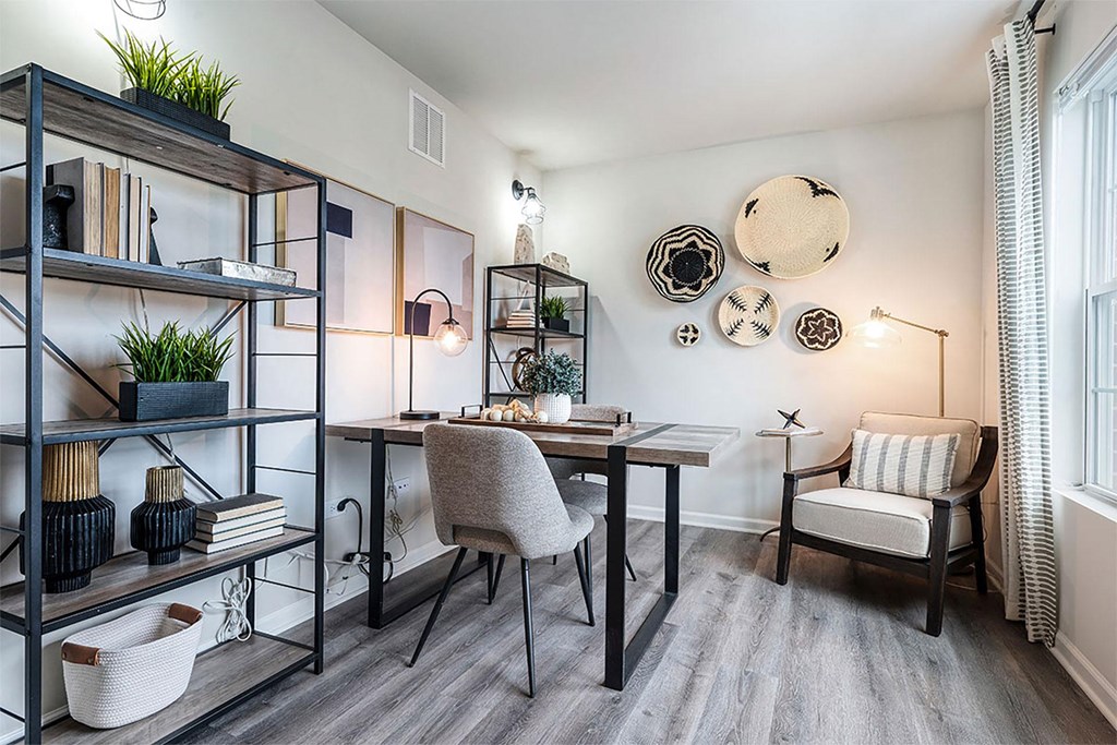 a home office with a desk and a chair and a window
