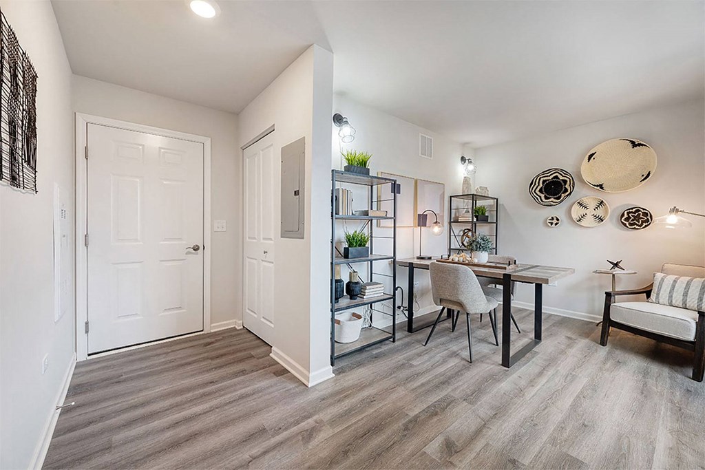 a living room and dining room with a table and chairs