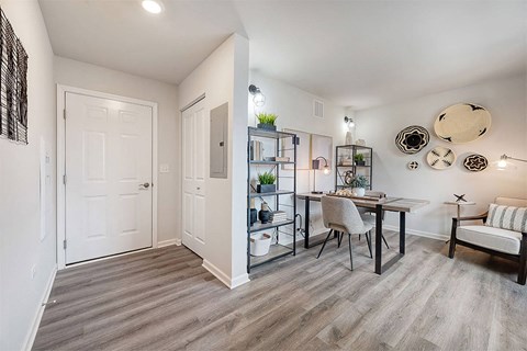 a living room and dining room with a table and chairs