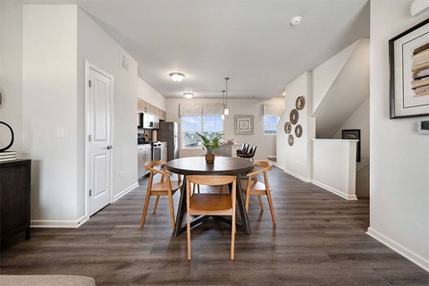 a dining room with a table and chairs