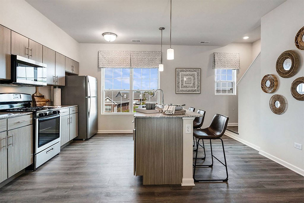 an open kitchen and dining room with stainless steel appliances