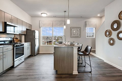 an open kitchen and dining room with stainless steel appliances