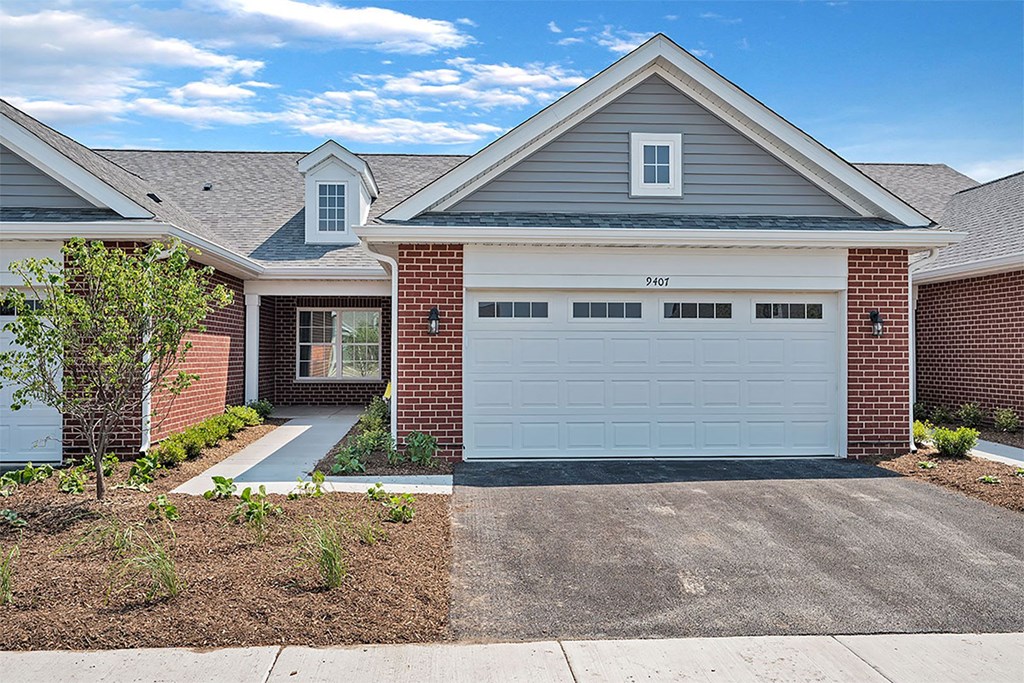 a white garage door in front of a house