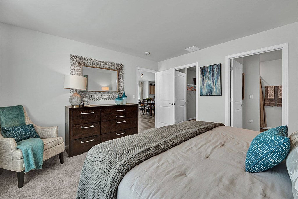 a bedroom with a bed and a dresser