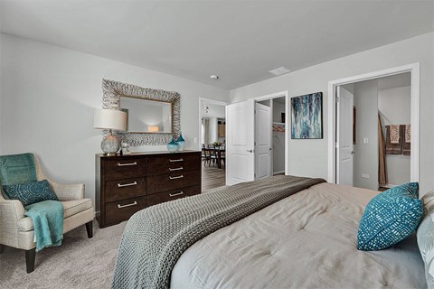 a bedroom with a bed and a dresser