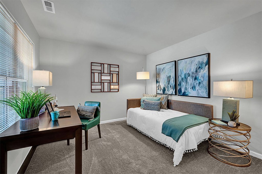 a bedroom with a bed and a desk