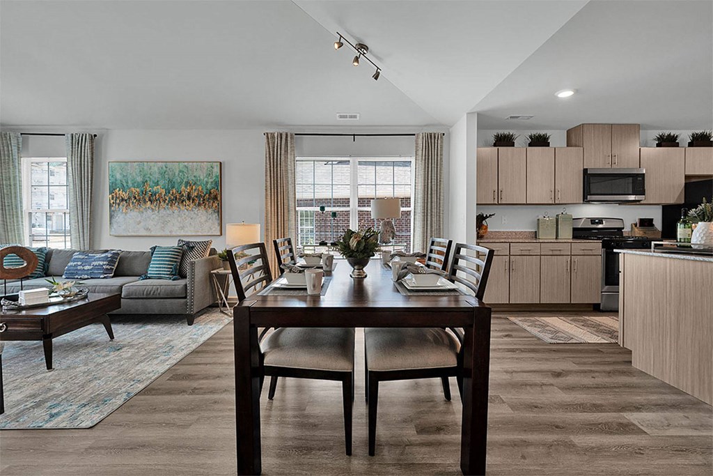 a kitchen and living room with a table and chairs