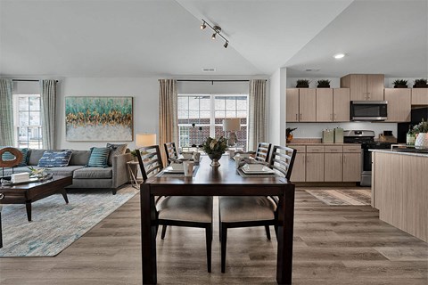 a kitchen and living room with a table and chairs