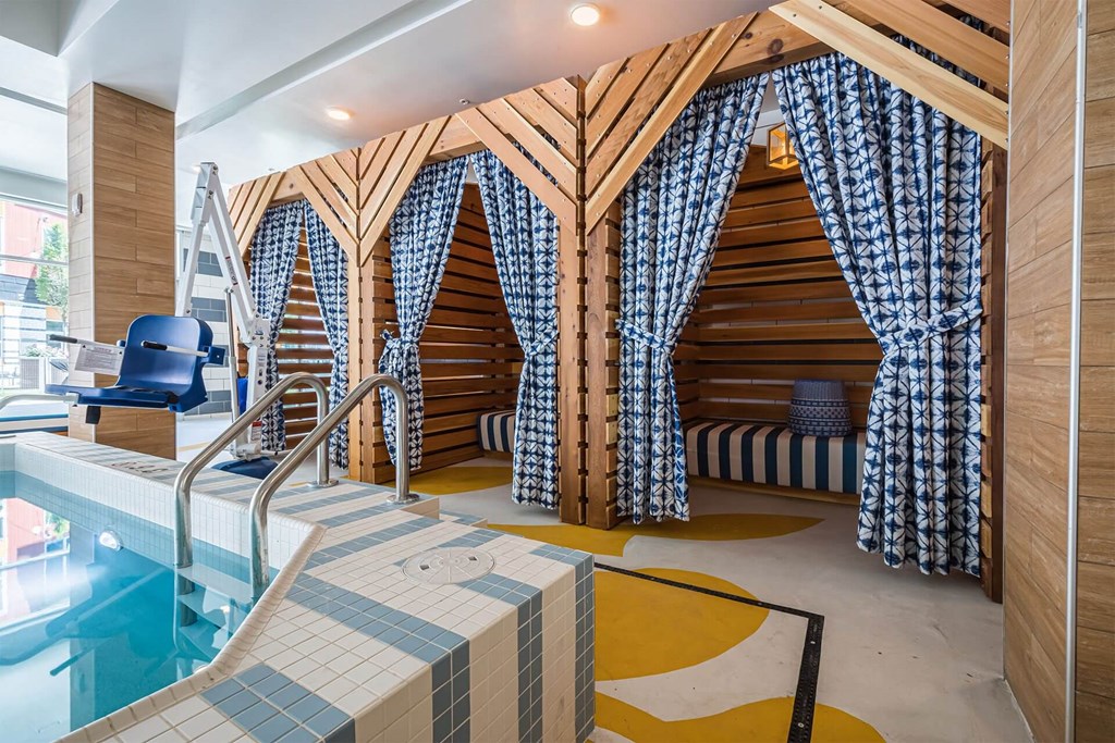 A room with a pool and a wooden wall.
