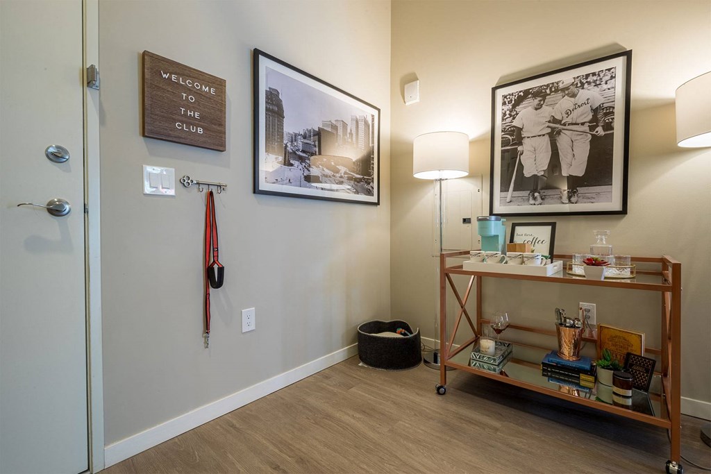 A room with a wooden floor and a wall with a sign that says "Welcome to the Club".