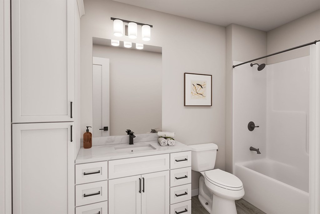 A white bathroom with a toilet, sink, and bathtub.