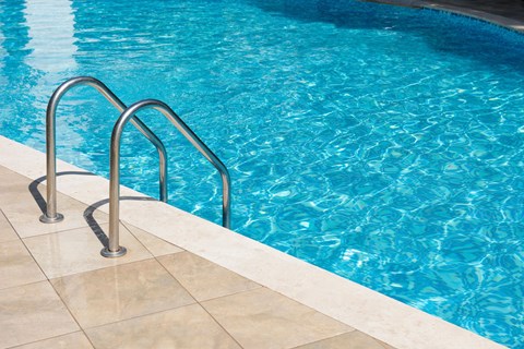 A pool with a metal ladder.