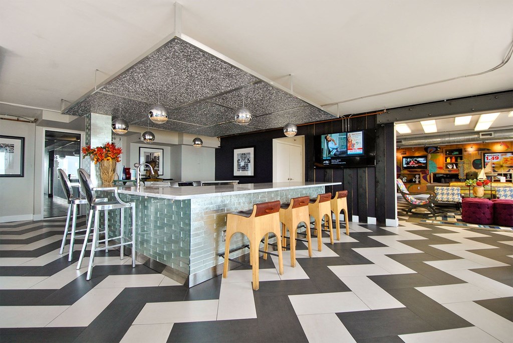 the lobby of a restaurant with a bar and chairs