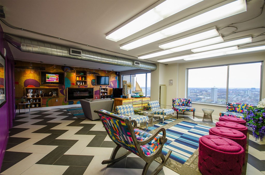 a living room with a checkered floor and tables and chairs