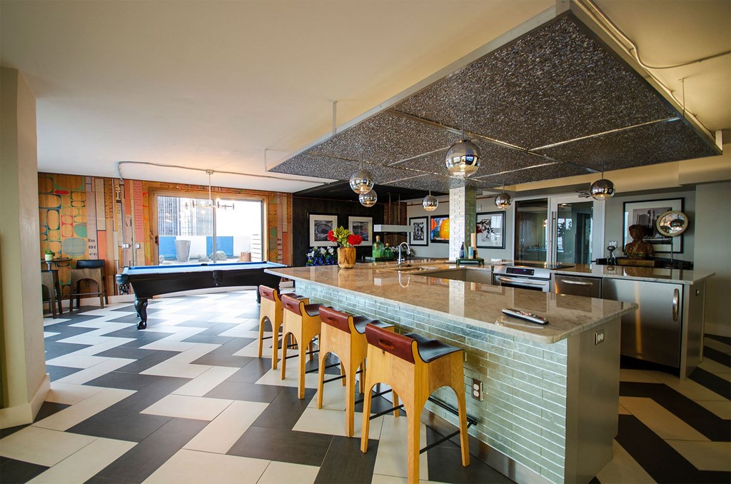 a large kitchen with a bar and a pool table