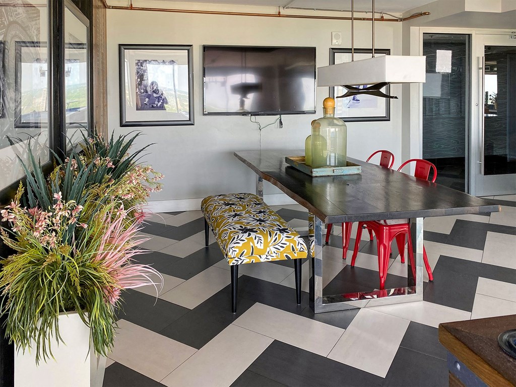 a dining room with a table and chairs and a checkered floor