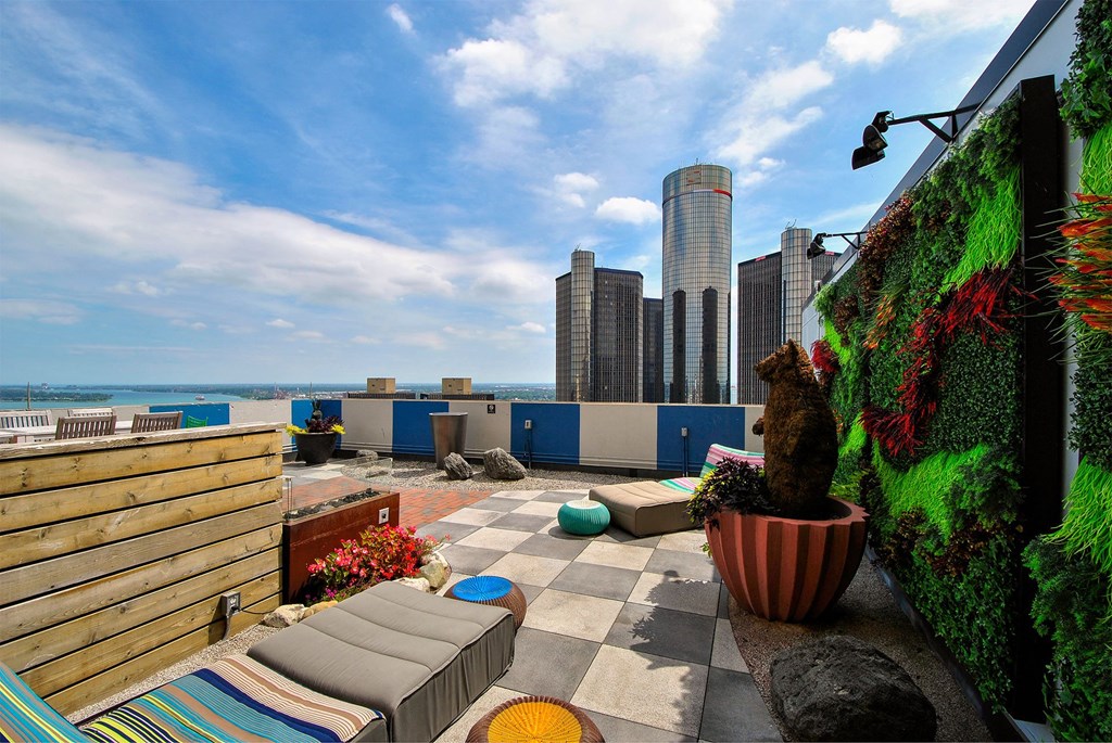 a rooftop patio with a view of the city and the ocean