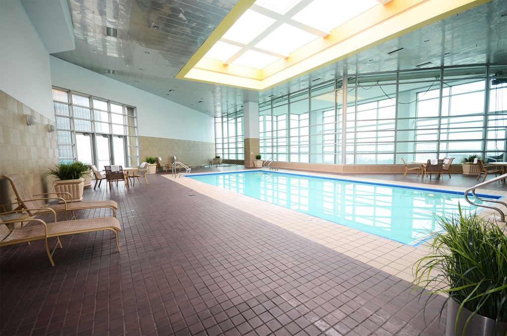 a swimming pool in a large building with windows