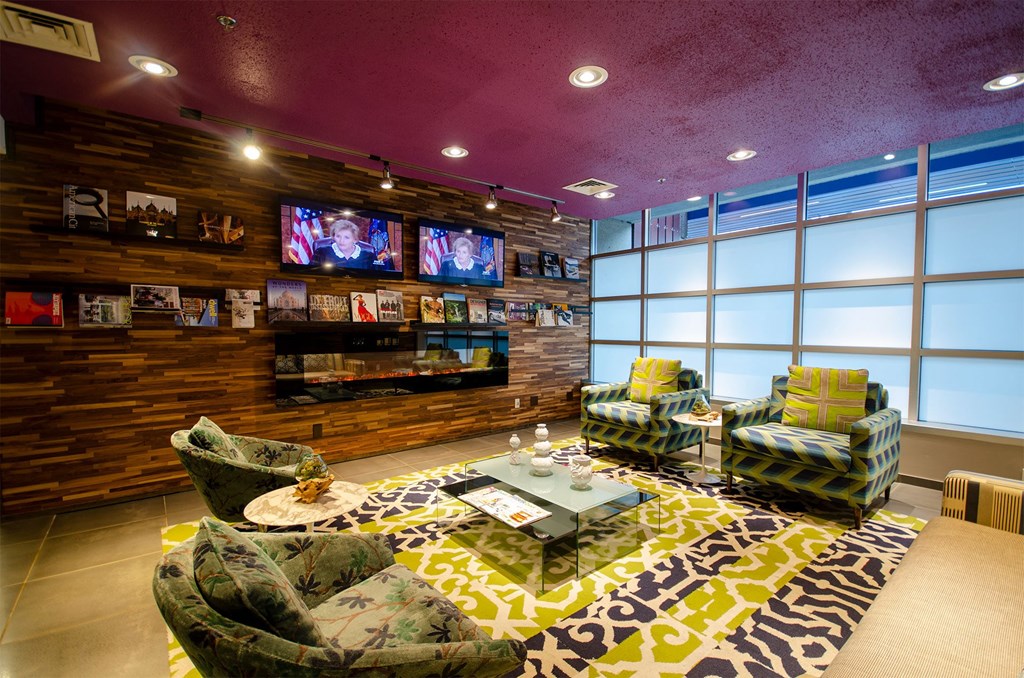 a living room with couches and chairs and a tv