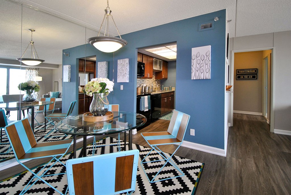 a dining room and kitchen with a glass table and chairs