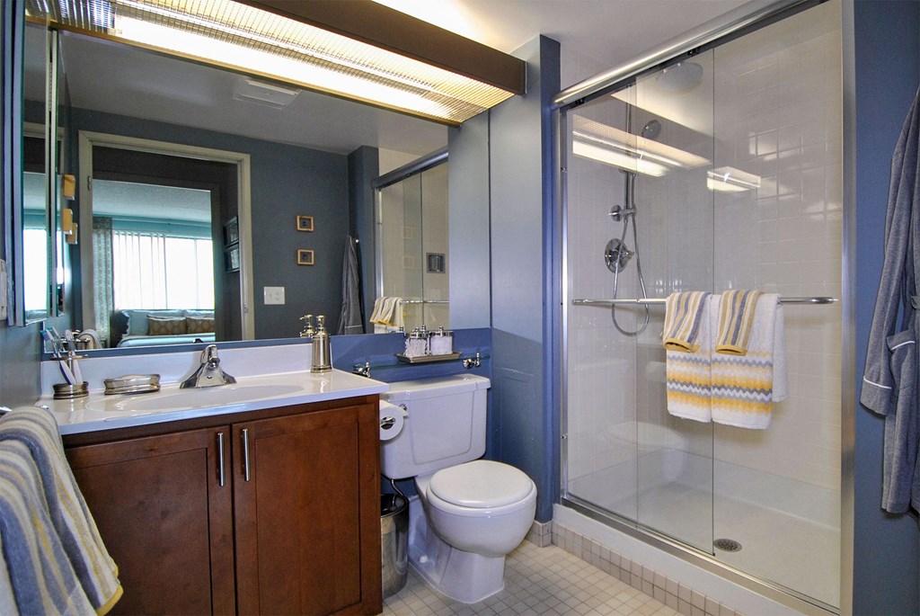 a bathroom with a toilet sink and shower