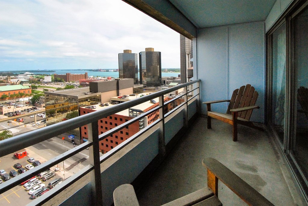 a balcony with a view of a city and the ocean