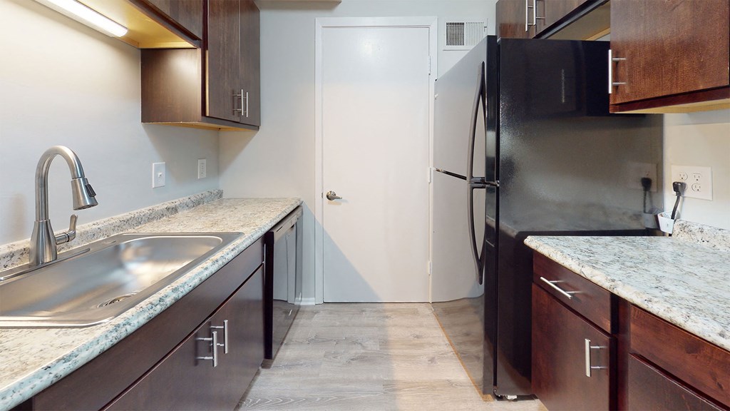 a kitchen with a stainless steel refrigerator and a sink