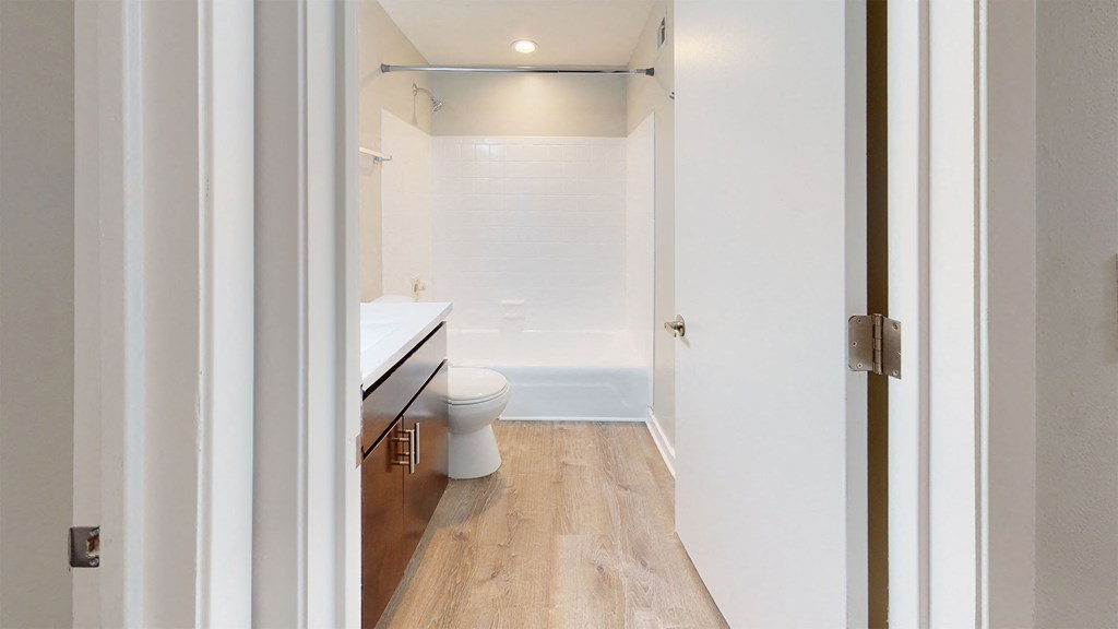 a white bathroom with a toilet and a sink