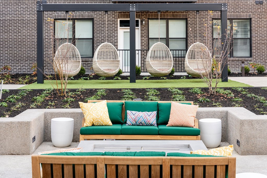 a lounge area with a couch and a pool in front of a building