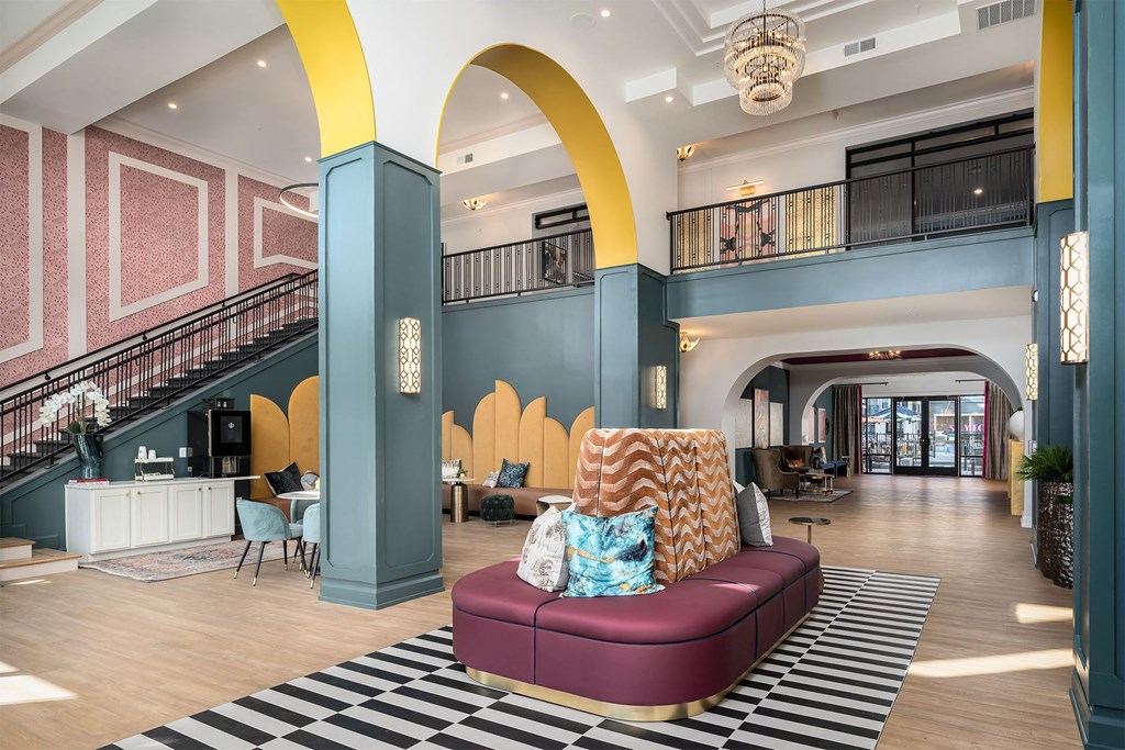 a lobby with a couch and a checkered rug