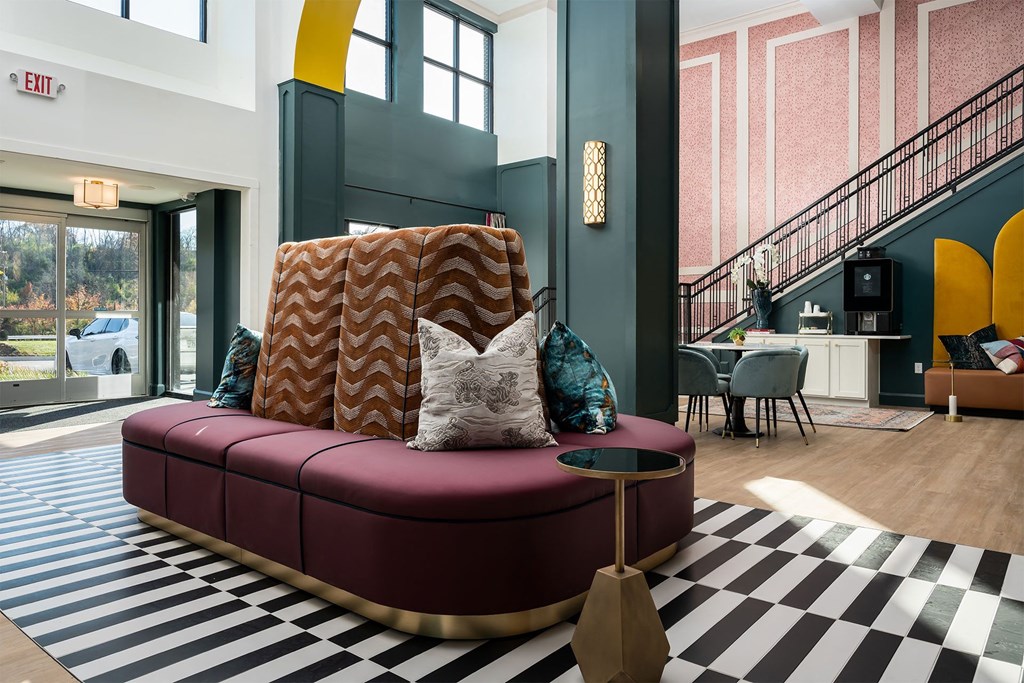 a living room with a red couch and a checkered floor