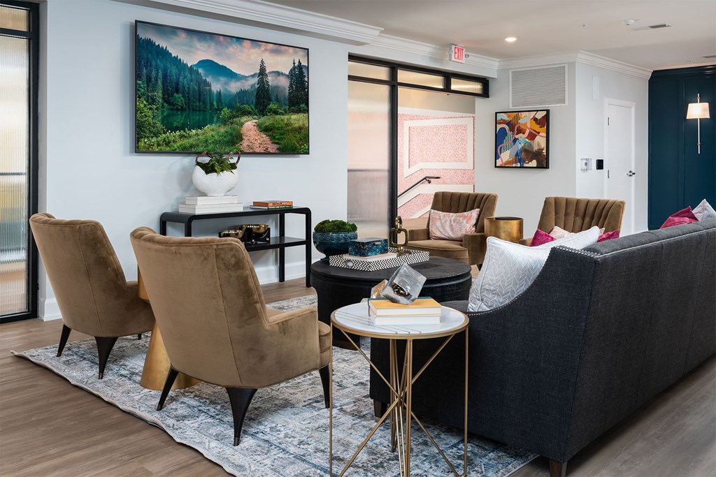 a living room with a couch and chairs and a table