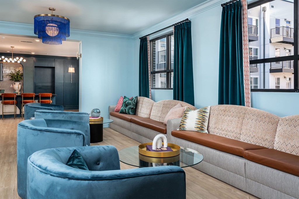 a living room with blue walls and brown furniture