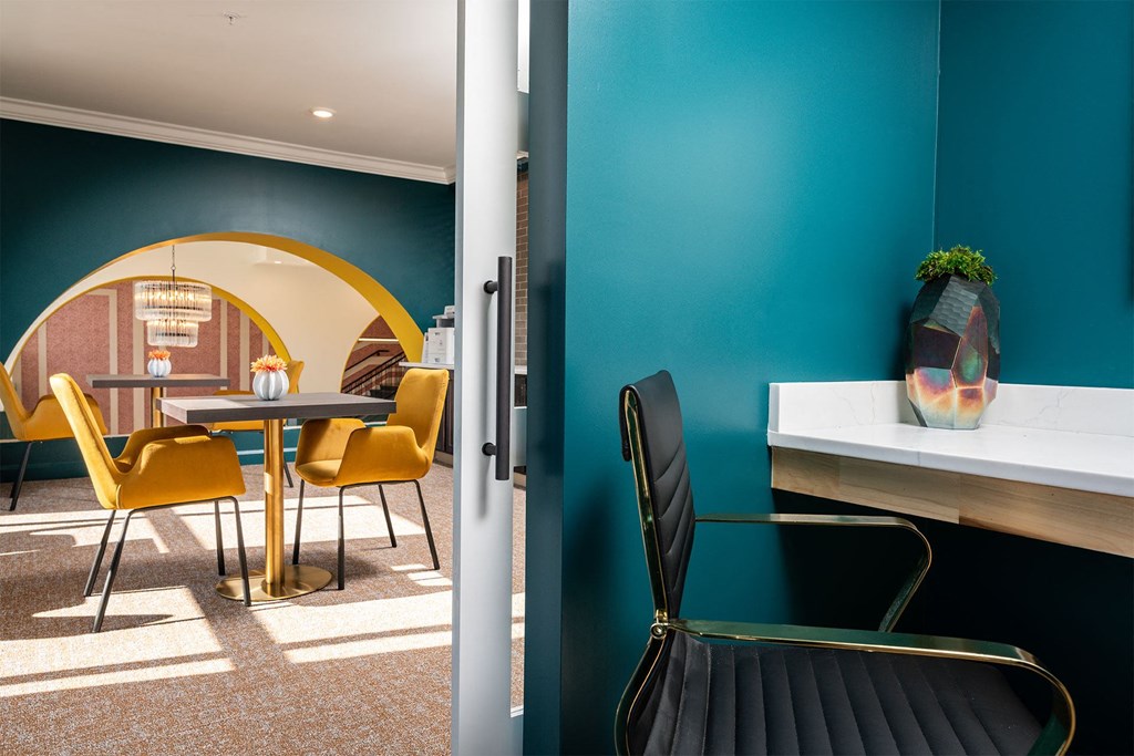 a dining room with a table and chairs and a blue wall