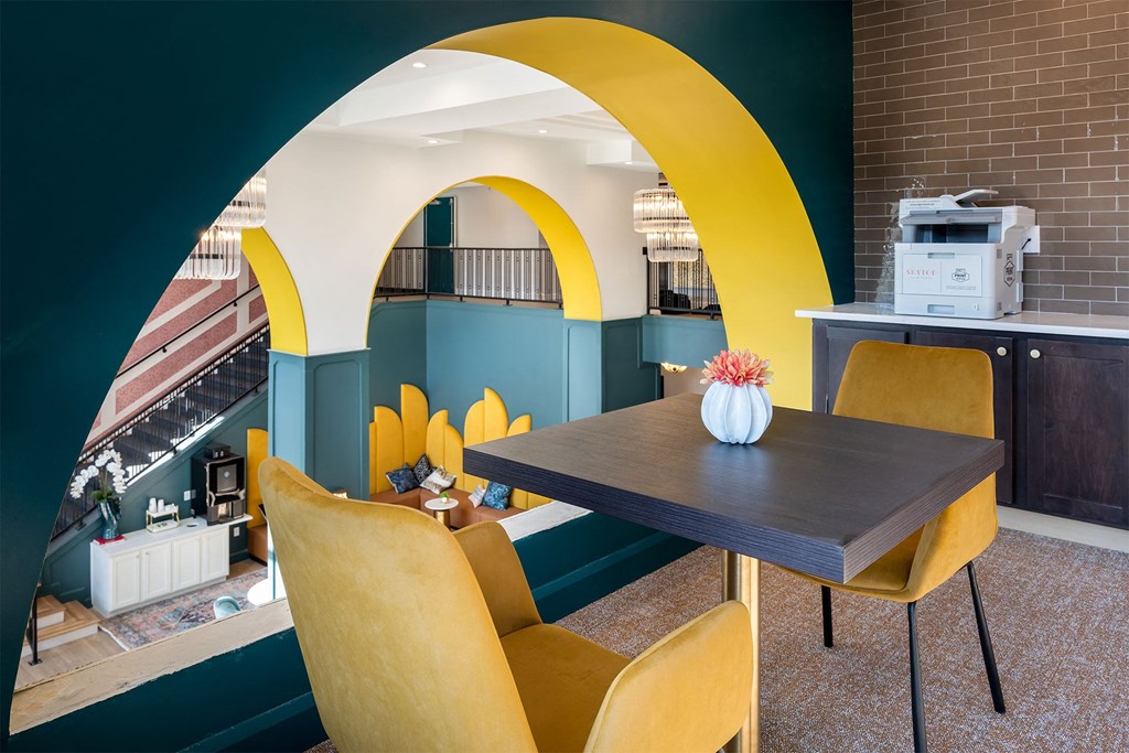 a dining room with yellow chairs and a table