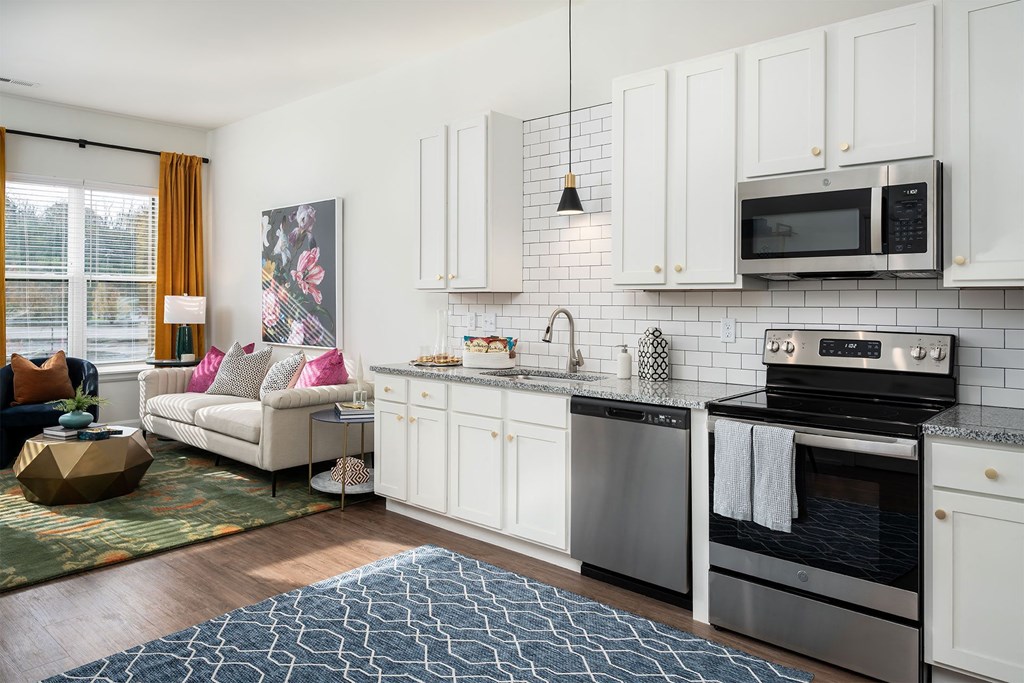 a living room with a couch and a kitchen