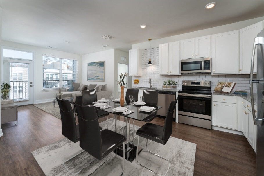 a kitchen and dining room with a table and chairs