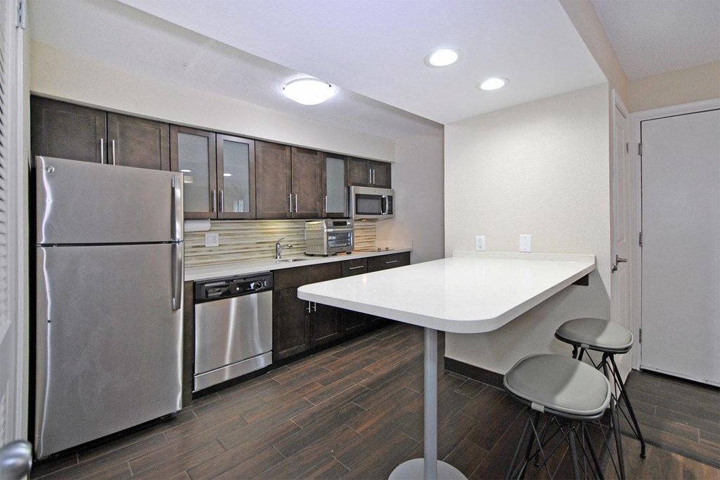 a kitchen with stainless steel appliances and a white counter top