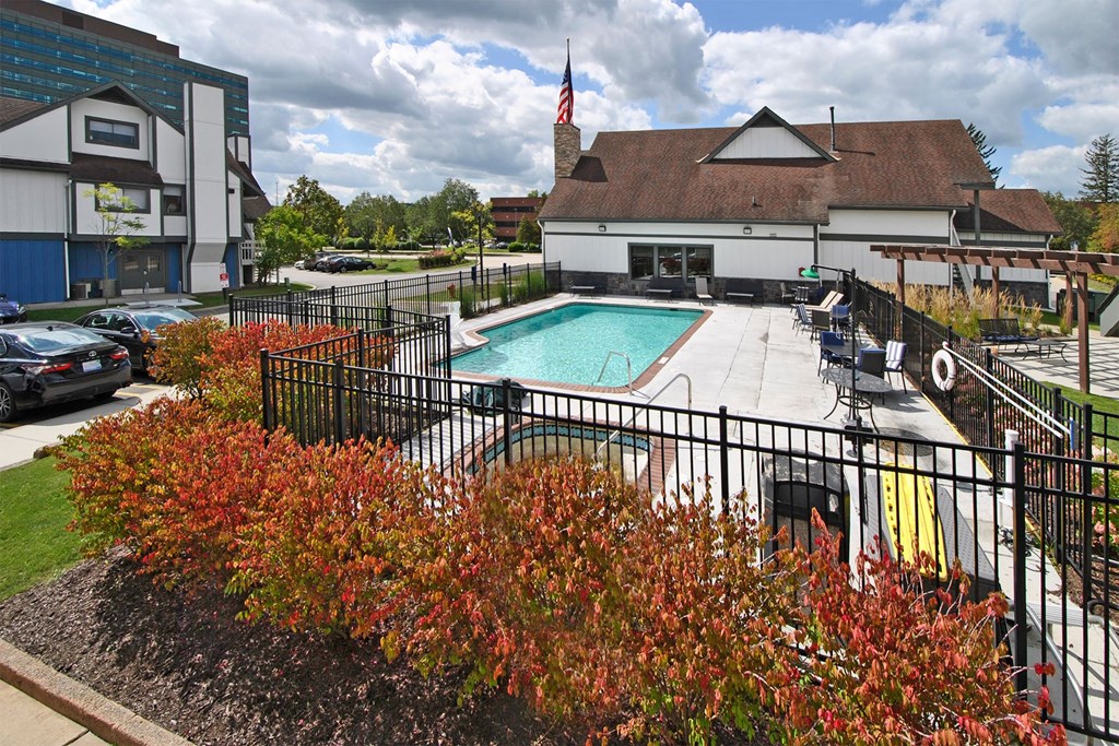 a swimming pool at a hotel with a building in the background