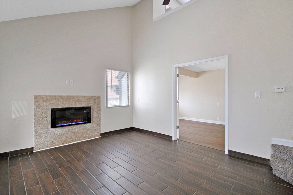the living room has a fireplace and hardwood floors
