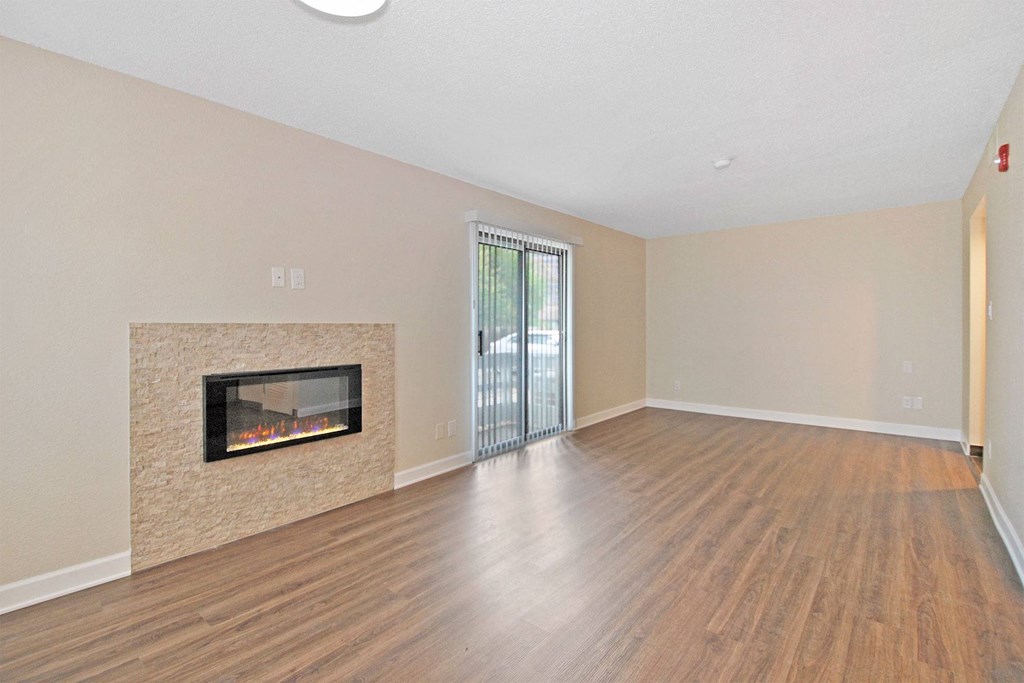 a living room with a fireplace and a door to a patio