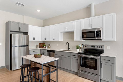 a kitchen with stainless steel appliances and white cabinets