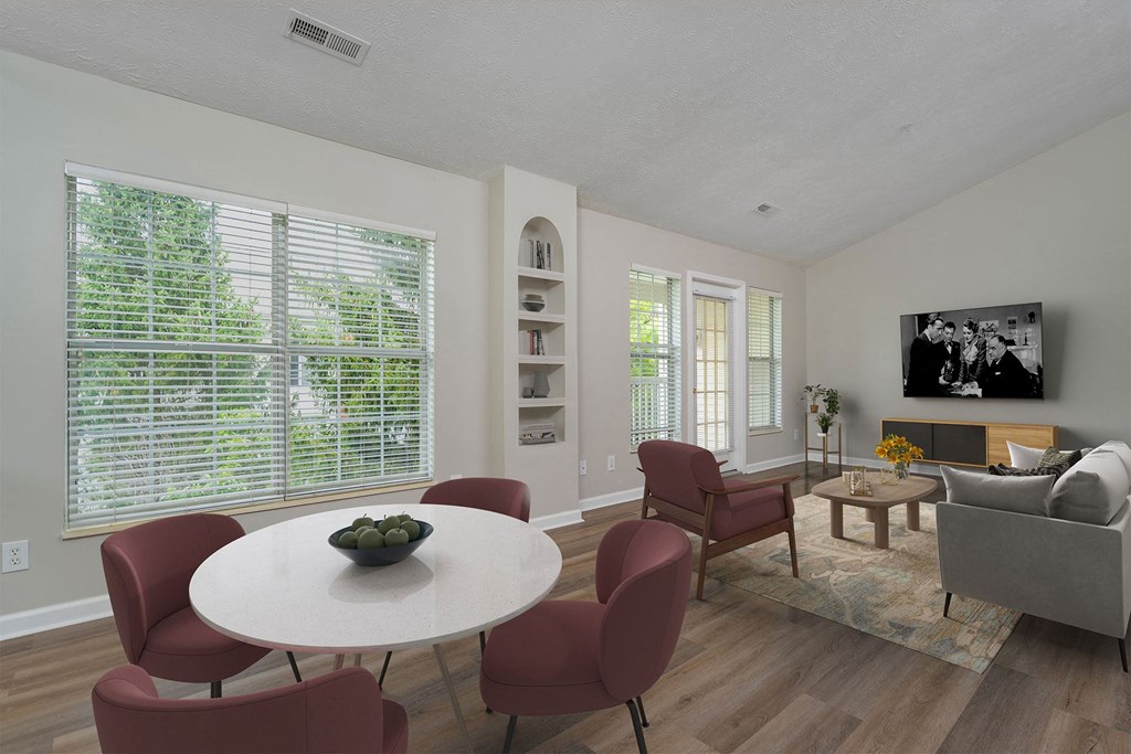a living room with a table and chairs and a television