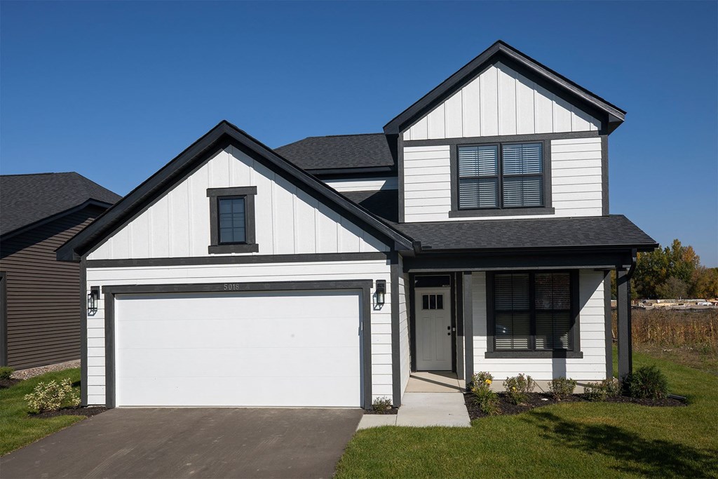a house with white siding and black shutters